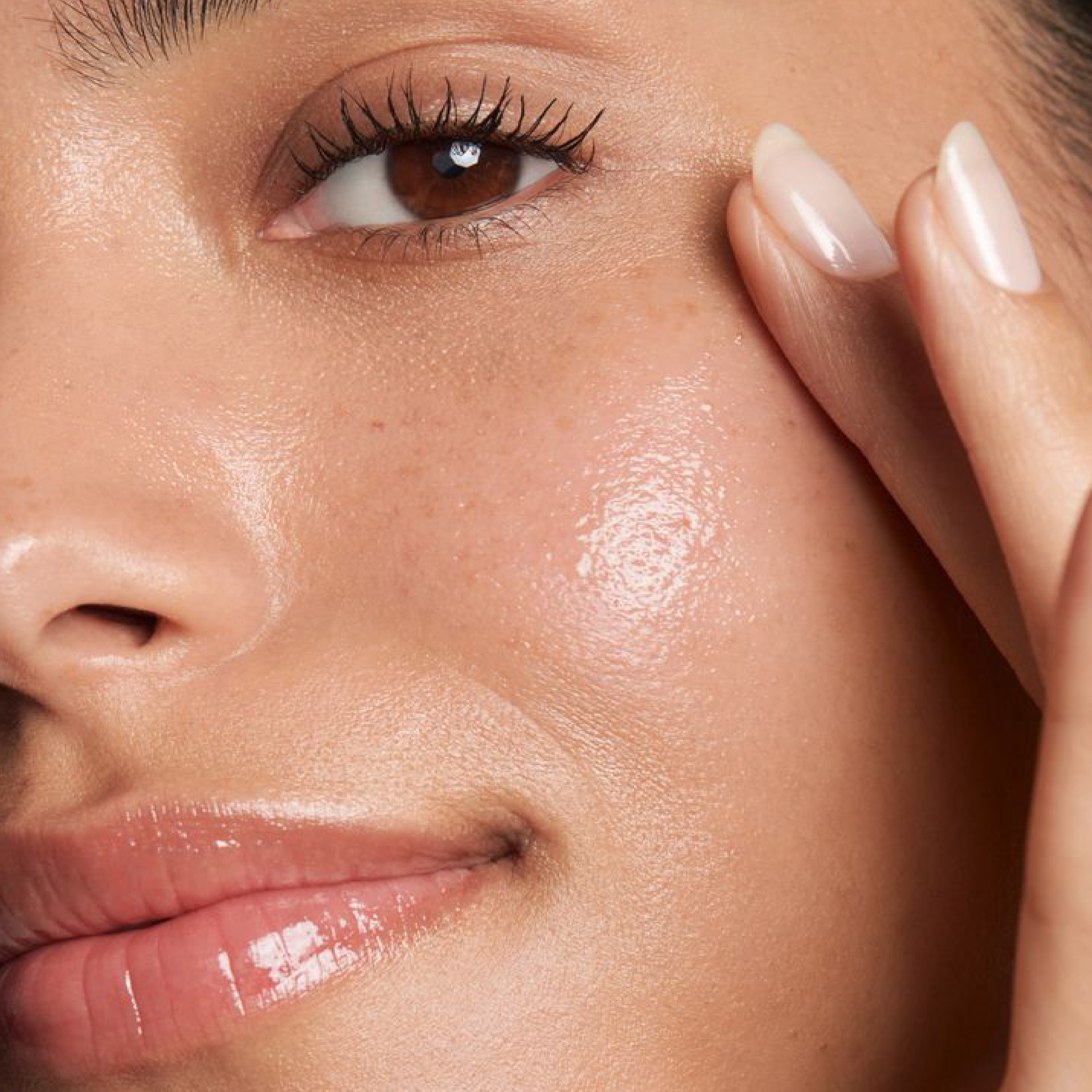 Close-up of glowing skin and softly defined lashes